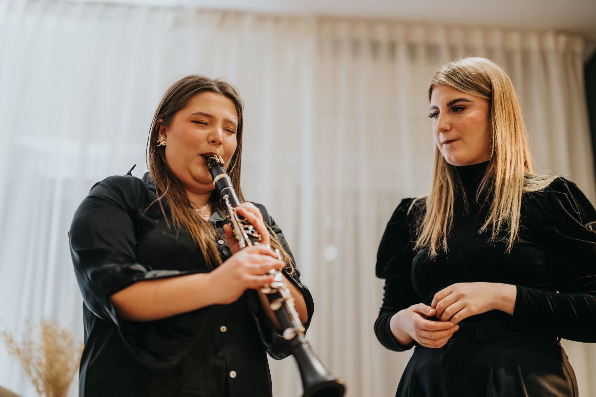 A female woman taking private clarinet lessons with a female teacher